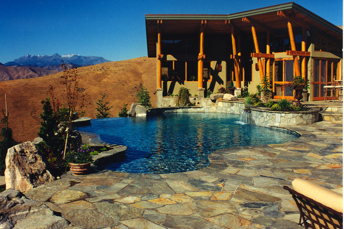 Pool deck and outdoor living area surrounding the pool at Water Features, a custom pool built in Eastern Washington, WA by Outdoor Elements Northwest