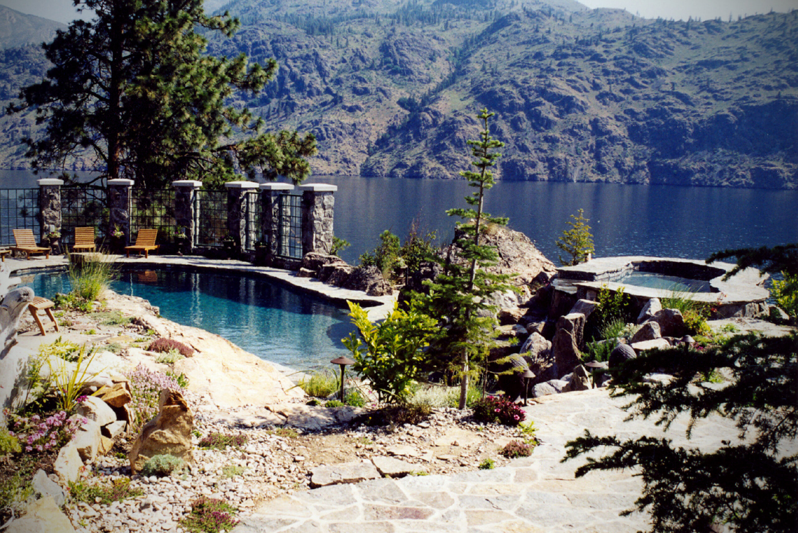 Raised tile spa spilling into the pool at Lake Chelan Pool & Spa, a custom pool built in Lake Chelan, WA, WA by Outdoor Elements Northwest